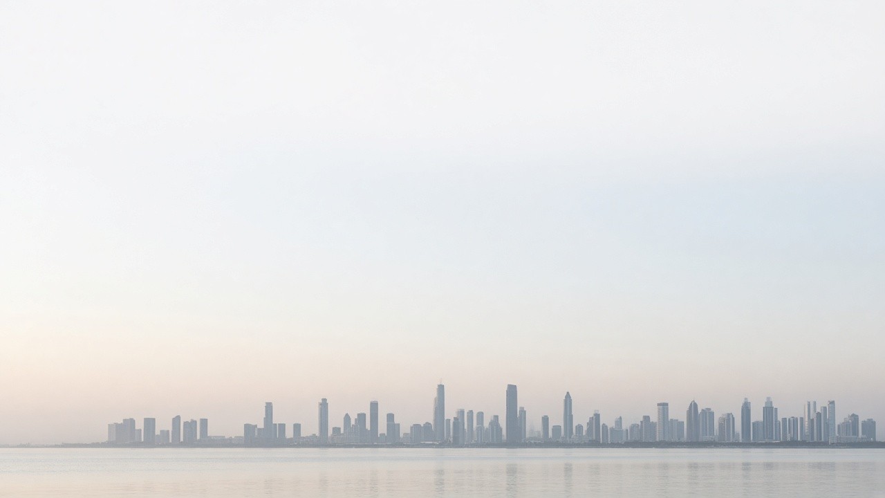 City skyline across a bay in morning haze